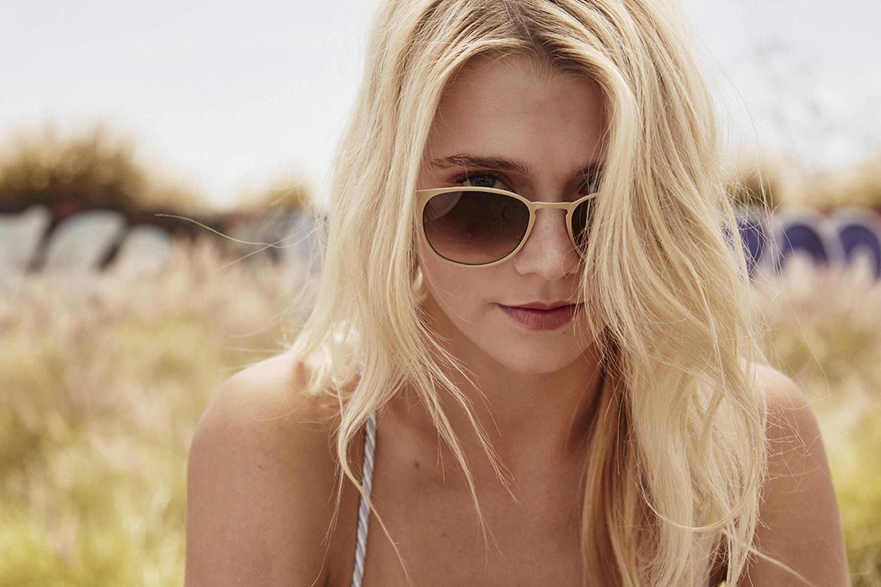 Brillenmarke Garrett Leight - Hübsche Frau mit blonden Haaren trägt eine Sonnenbrille